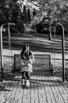 Young woman sitting on a swing chair