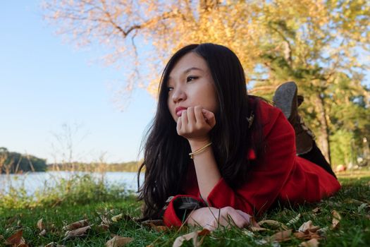 Woman laying on grass looking happy