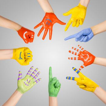 painted children's hands in different colors with smilies