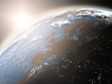 Space view of the sun rising over Europe on planet Earth. Elements of this image furnished by NASA.