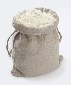 Isolated small sack with white flour on the white background