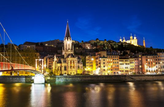 night view from St Georges footbridge in Lyon city with Fourviere cathedral, France