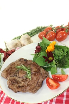 a roasted ribeye steak with wild herb salad