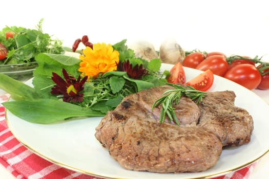 a roasted ribeye steak with wild herb salad