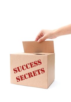 Hand opening a box containing secrets of success 