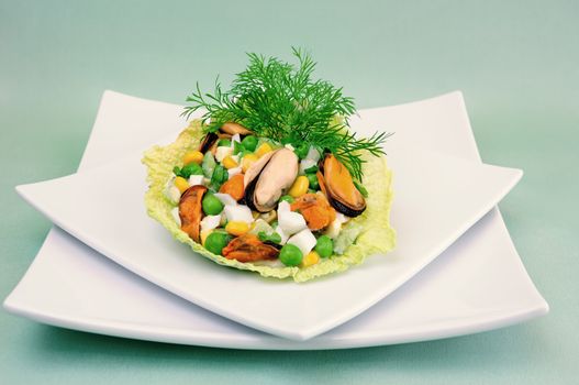 Seafood salad with vegetables in the leaves of savoy cabbage