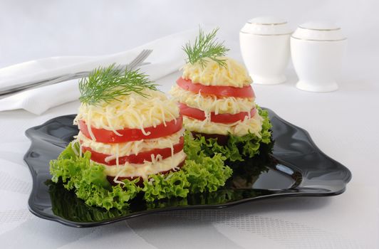 Snack bars of tomato under acute stuffed eggs with cheese