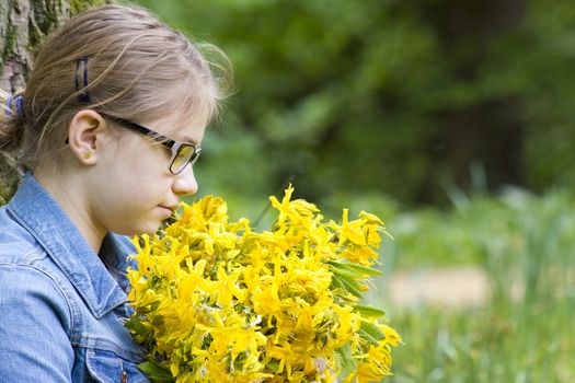 young girl with big bouquet of spring flowers