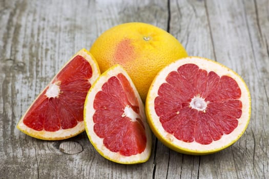 red grapefruit on old wooden background