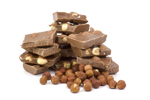 chocolate and hazelnuts on white background