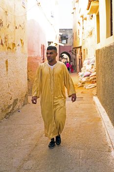 FES, MAROCCO - October 15 2013 : Man walking in the medina on Eid al-Adha. The festival is celebrated by sacrificing a lamb or other animal and distributing the meat to relatives, friends, and the poor.