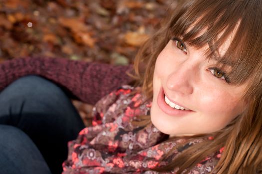 Young woman in the autumn at a cold november day