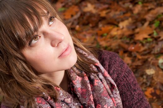 Young woman in the autumn at a cold november day