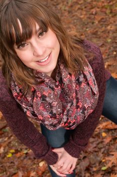 Young woman in the autumn at a cold november day