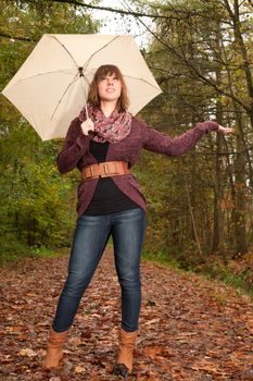 Young woman in the autumn at a cold november day