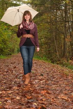 Young woman in the autumn at a cold november day