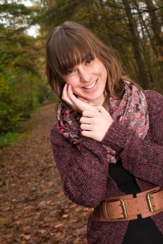 Young woman in the autumn at a cold november day