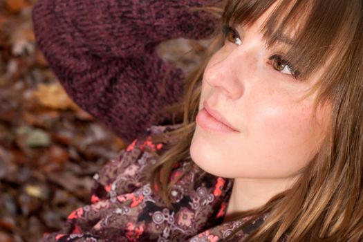 Young woman in the autumn at a cold november day