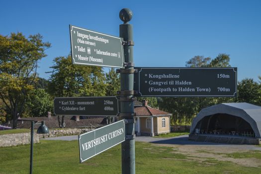 The sign is just outside the main entrance and show the way to various points of interest. Image is shot at Fredriksten Fortress in Halden, Norway a day in September 2013.