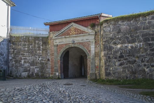 The building and the port was built in 1765 as the sign over the gate shows. Image is shot at Fredriksten fortress in Halden, Norway a day in September 2013.