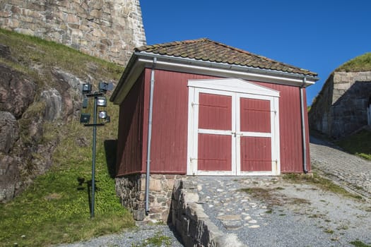 The outbuilding is old and built of wood and is located just under Prince Chritians bastion. Image is shot at Fredriksten fortress in Halden, Norway a day in September 2013.