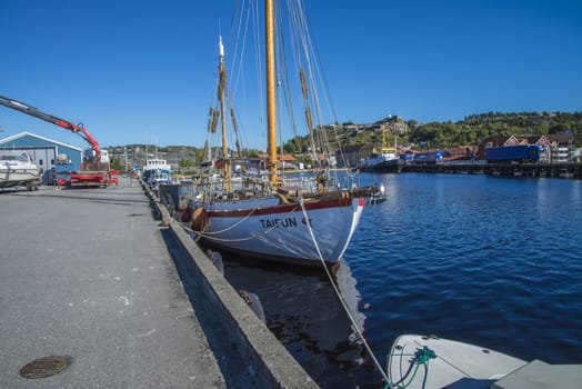 Old dignified sailboat built of wood. Taifun is moored to the dock at the port of Halden, Norway. Photo is shot one day in September 2013.