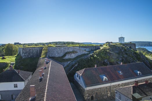 Under king's bastion  is located under over king's bastion shown at the right in photo with the Bell tower just in front. The roof in the foreground belongs to Eastern curtain wall (built in 1664). Image is shot at Fredriksten Fortress in Halden, Norway a day in September 2013.