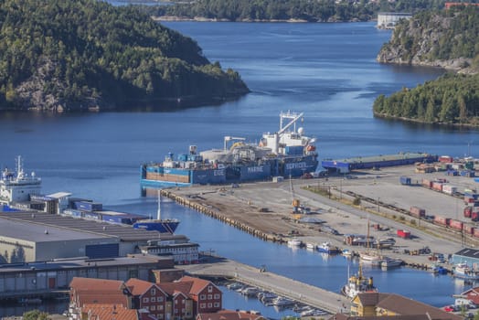 Image is shot from the top of Fredriksten fortress and shows the port of Halden, Norway and MV Eide Trader moored to the dock. Image is shot in September 2013
