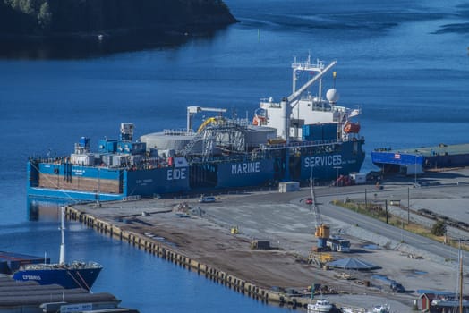 Image is shot from the top of Fredriksten fortress and shows the port of Halden, Norway and MV Eide Trader moored to the dock. Image is shot in September 2013