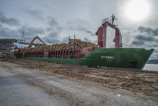 MV St.pauli leaving Halden, (Norway) harbor with a cargo full of timber. Photo is shot 9 October 2013. Vessel's Details: Ship type: General cargo, Year Built: 1983, Length x breadth: 92 m X 15 m, Gross Tonnage: 3075, Dead Weight: 3219 t, Flag: Gibraltar (GI).