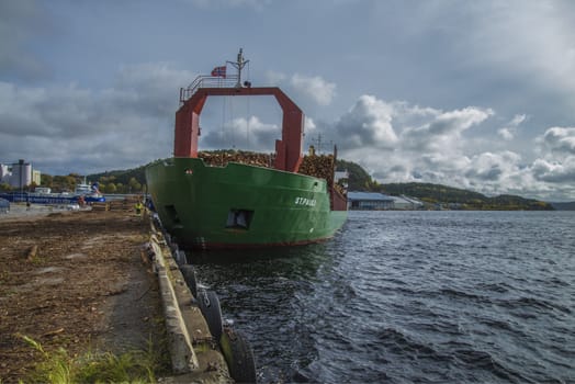 MV St.pauli leaving Halden, (Norway) harbor with a cargo full of timber. Photo is shot 9 October 2013. Vessel's Details: Ship type: General cargo, Year Built: 1983, Length x breadth: 92 m X 15 m, Gross Tonnage: 3075, Dead Weight: 3219 t, Flag: Gibraltar (GI).