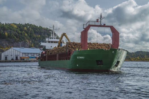 MV St.pauli leaving Halden, (Norway) harbor with a cargo full of timber. Photo is shot 9 October 2013. Vessel's Details: Ship type: General cargo, Year Built: 1983, Length x breadth: 92 m X 15 m, Gross Tonnage: 3075, Dead Weight: 3219 t, Flag: Gibraltar (GI).