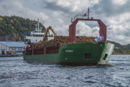 MV St.pauli leaving Halden, (Norway) harbor with a cargo full of timber. Photo is shot 9 October 2013. Vessel's Details: Ship type: General cargo, Year Built: 1983, Length x breadth: 92 m X 15 m, Gross Tonnage: 3075, Dead Weight: 3219 t, Flag: Gibraltar (GI).