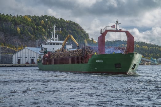 MV St.pauli leaving Halden, (Norway) harbor with a cargo full of timber. Photo is shot 9 October 2013. Vessel's Details: Ship type: General cargo, Year Built: 1983, Length x breadth: 92 m X 15 m, Gross Tonnage: 3075, Dead Weight: 3219 t, Flag: Gibraltar (GI).