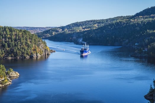 MV Lysbris sailing through Ringdalsfjord from Halden, Norway harbor and out to the open ocean. Vessel's Details: Ship Type: Cargo / container ship, built 1999, Length x Breadth: 129 m X 18 m, Gross Tonnage: 7409, DWT (deadweight tons): 7500 h, Flag: Norway (NO). Photo is shot from Svinesund bridge 18 October 2013.