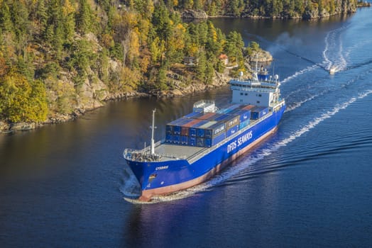 MV Lysbris sailing through Ringdalsfjord from Halden, Norway harbor and out to the open ocean. Vessel's Details: Ship Type: Cargo / container ship, built 1999, Length x Breadth: 129 m X 18 m, Gross Tonnage: 7409, DWT (deadweight tons): 7500 h, Flag: Norway (NO). Photo is shot from Svinesund bridge 18 October 2013.