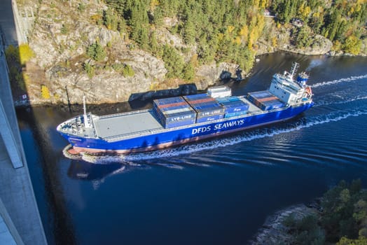 MV Lysbris sailing through Ringdalsfjord from Halden, Norway harbor and out to the open ocean. Vessel's Details: Ship Type: Cargo / container ship, built 1999, Length x Breadth: 129 m X 18 m, Gross Tonnage: 7409, DWT (deadweight tons): 7500 h, Flag: Norway (NO). Photo is shot from Svinesund bridge 18 October 2013.