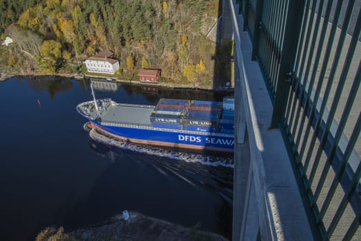 MV Lysbris sailing through Ringdalsfjord from Halden, Norway harbor and out to the open ocean. Vessel's Details: Ship Type: Cargo / container ship, built 1999, Length x Breadth: 129 m X 18 m, Gross Tonnage: 7409, DWT (deadweight tons): 7500 h, Flag: Norway (NO). Photo is shot from Svinesund bridge 18 October 2013.