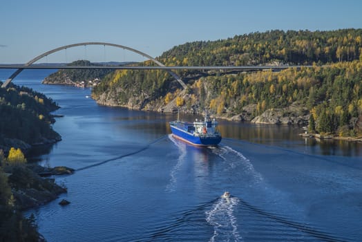 MV Lysbris sailing through Ringdalsfjord from Halden, Norway harbor and out to the open ocean. Vessel's Details: Ship Type: Cargo / container ship, built 1999, Length x Breadth: 129 m X 18 m, Gross Tonnage: 7409, DWT (deadweight tons): 7500 h, Flag: Norway (NO). Photo is shot from Svinesund bridge 18 October 2013.