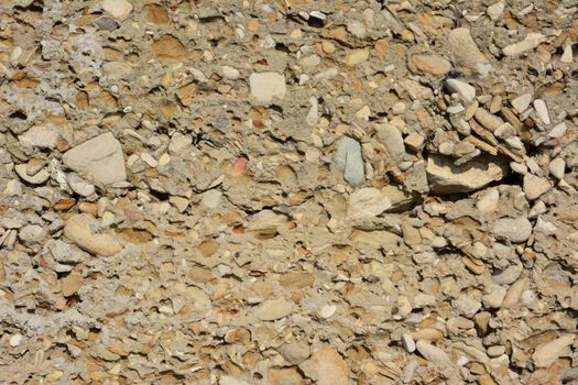 old concrete wall with small stone