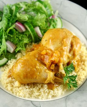 Apricot chicken drumsticks with a green side salad.