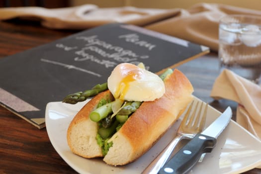 Delicious asparagus and mashed peas topped with a poached egg on a crispy baguette.