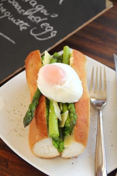 Delicious asparagus and mashed peas topped with a poached egg on a crispy baguette.