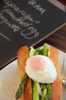 Delicious asparagus and mashed peas topped with a poached egg on a crispy baguette.