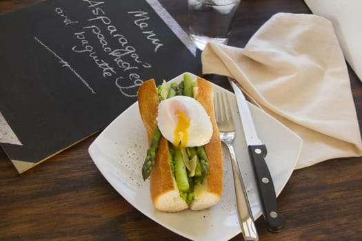 Delicious asparagus and mashed peas topped with a poached egg on a crispy baguette.