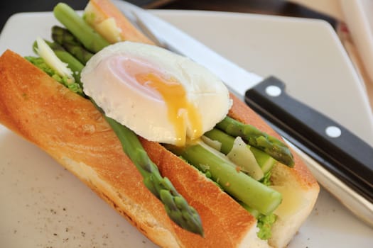 Delicious asparagus and mashed peas topped with a poached egg on a crispy baguette.