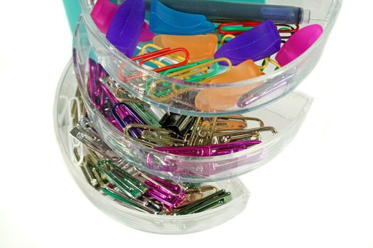 Assorted paper clips in the drawers of an organizer.
