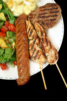 BBQ chicken tenderloin skewers, beef sausage, beef patty with spinach salad and potato salad.