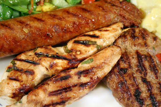 BBQ chicken tenderloin skewers, beef sausage, beef patty with spinach salad and potato salad.