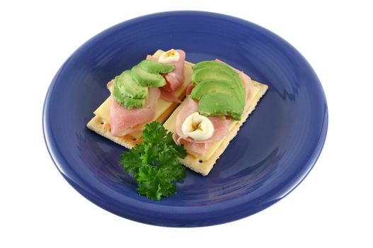 Ham, cheese and avocado crackers with hot english mayo.